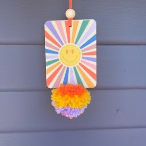 Smiley face car air freshener with pompom